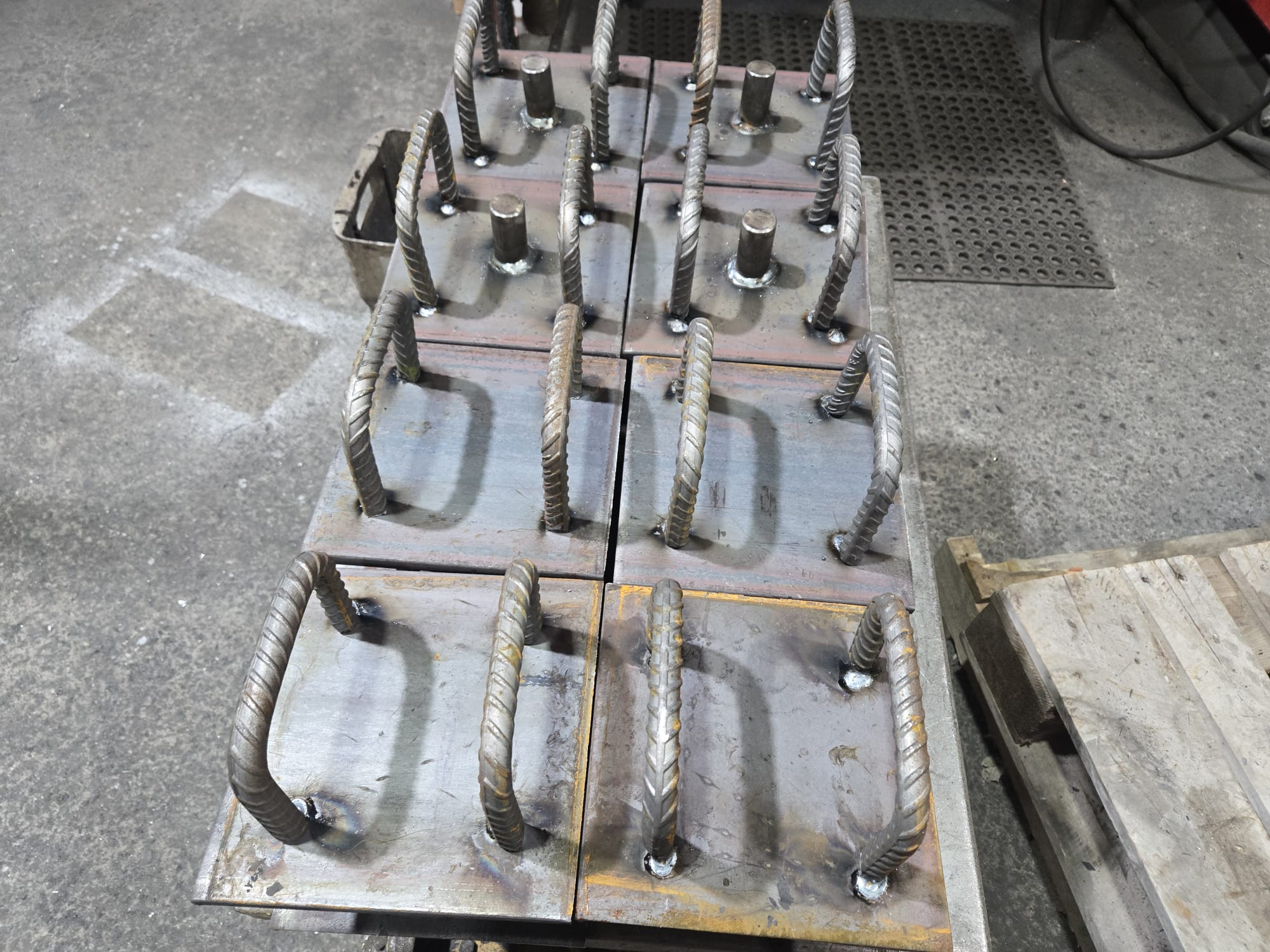 Real batch of repeated Cast-In Plate assemblies showing consistent fabrication and identification