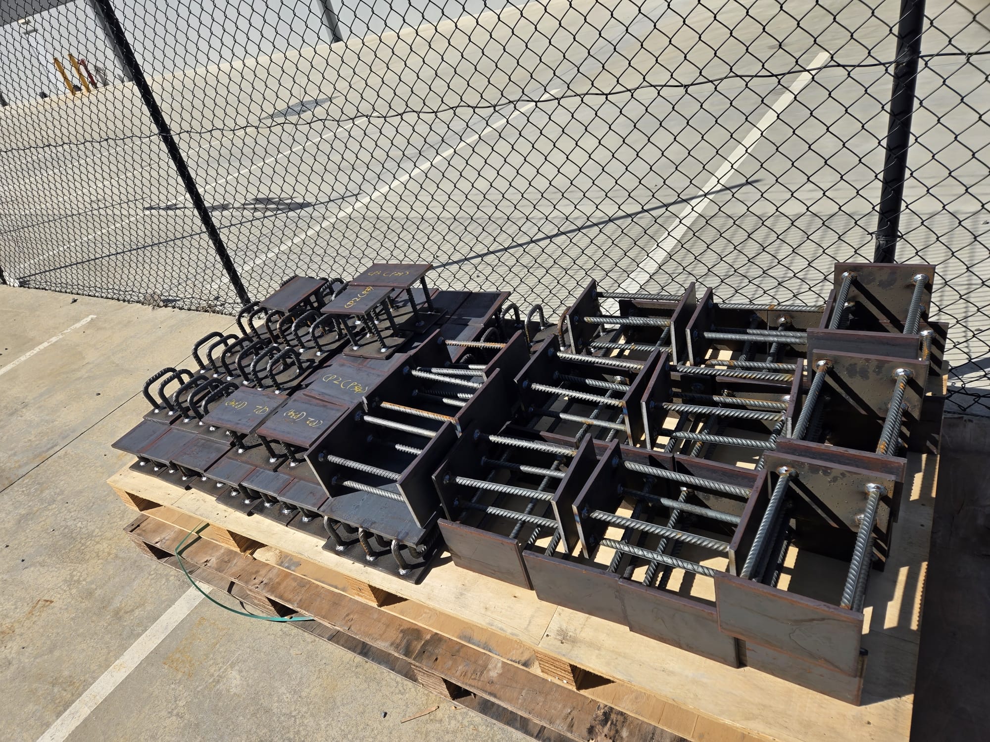 Large mixed batch of fabricated Cast-In Plate assemblies prepared on pallets