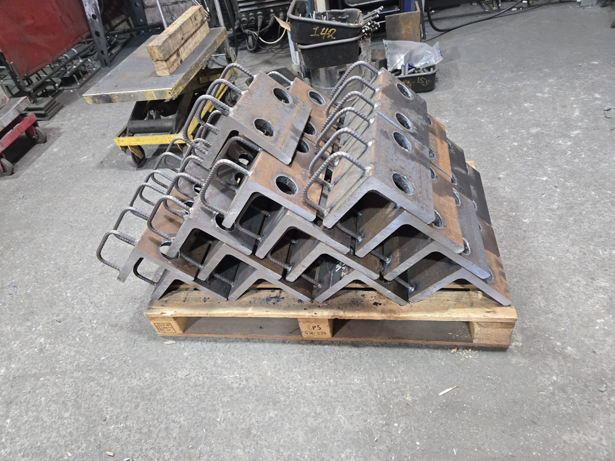 Repeated angled Cast-In Plate assemblies with holes and reinforcing bars