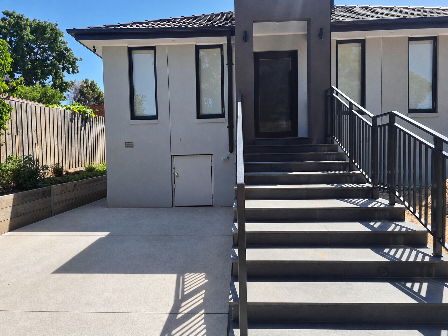 Dark steel handrail and balustrade package at a building entrance